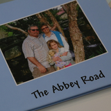 A family's personal photo book of their adoption, titled The Abbey Road